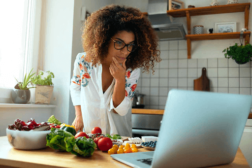 woman looking at the recipe on the laptop